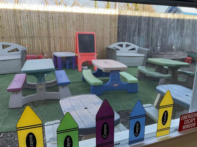 A colorful outdoor play area with picnic tables